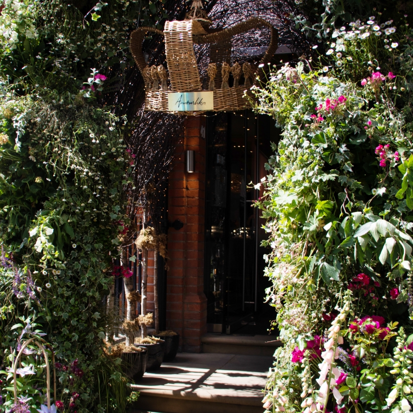 storefront decorated with greenery and flowers 