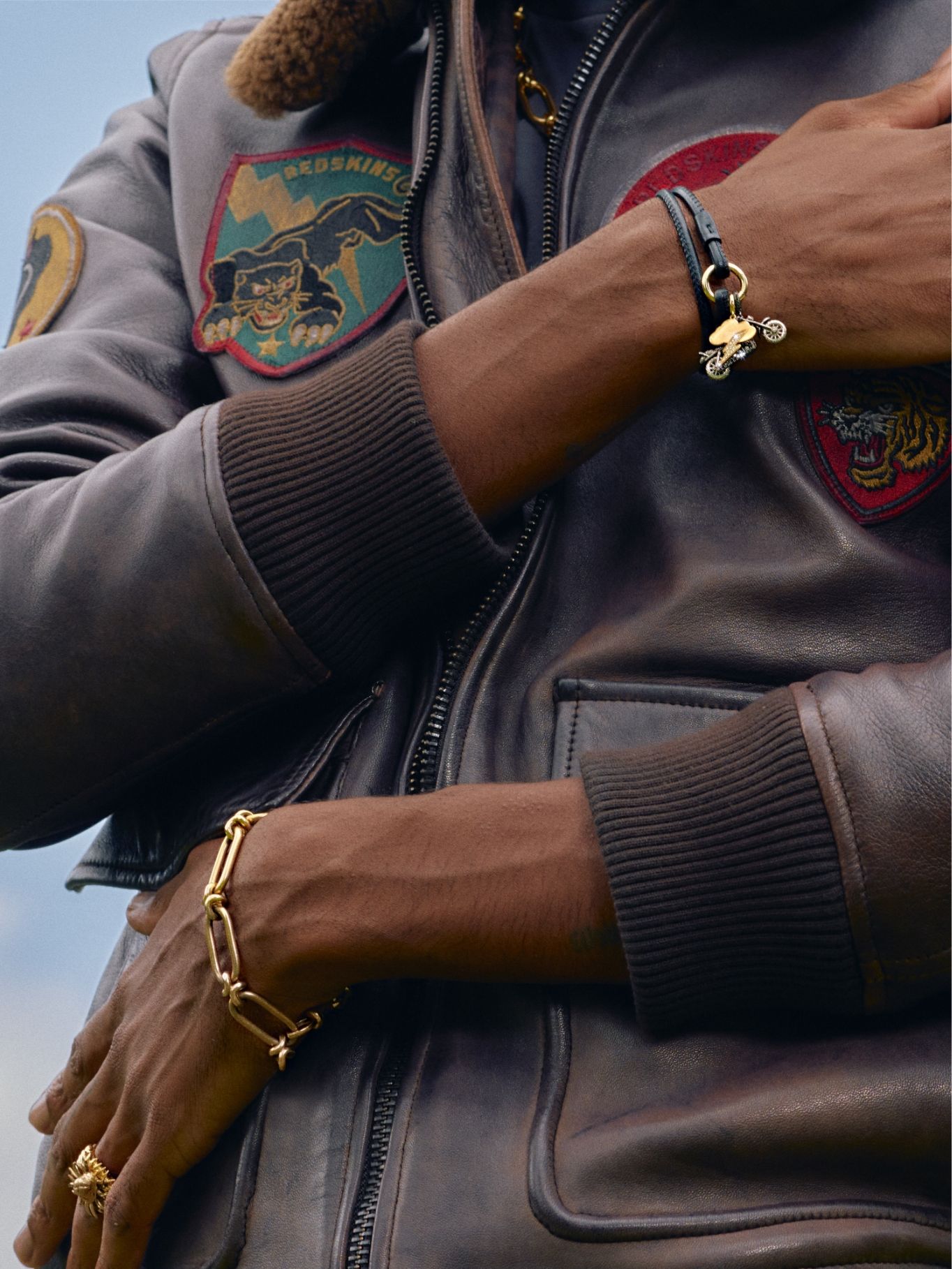 man wearing leather jacket and gold chain